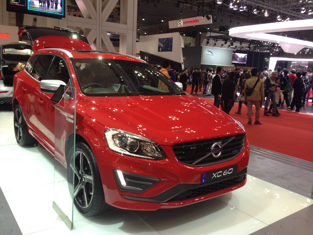 Red mid-size SUV front view with prominent headlights and sporty design