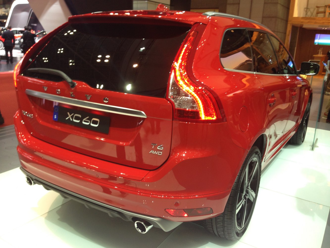 Rear view of red SUV with distinct taillights and dual exhaust.