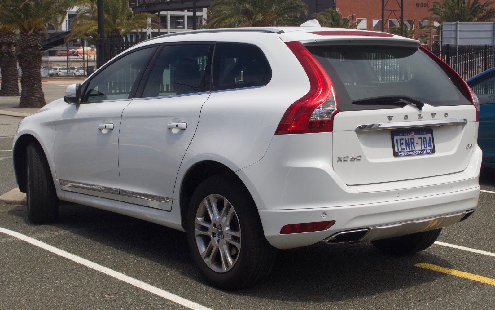 Rear view of white SUV with vertical taillights and rear parking sensors