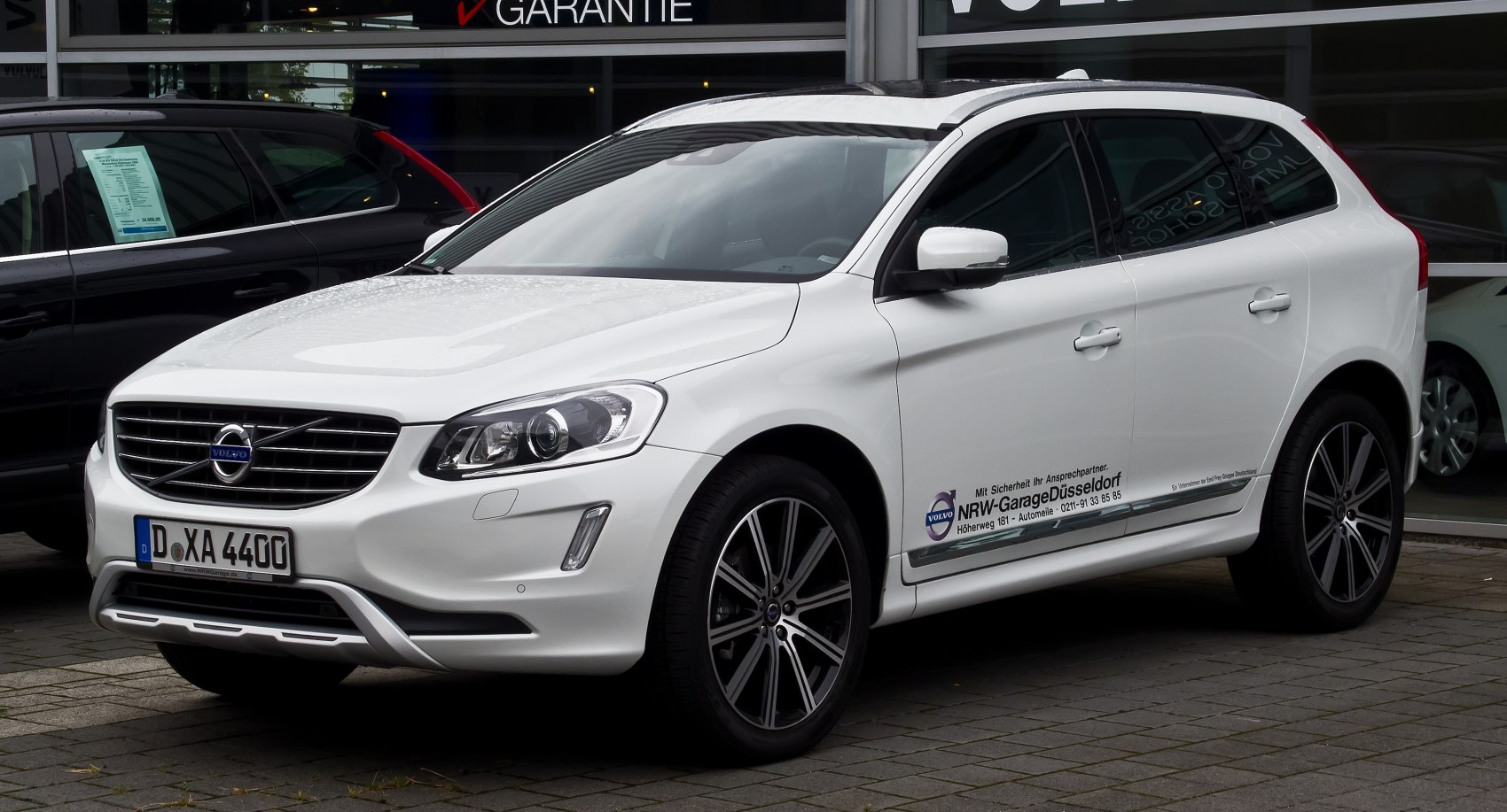Front view and alloy wheels of white SUV