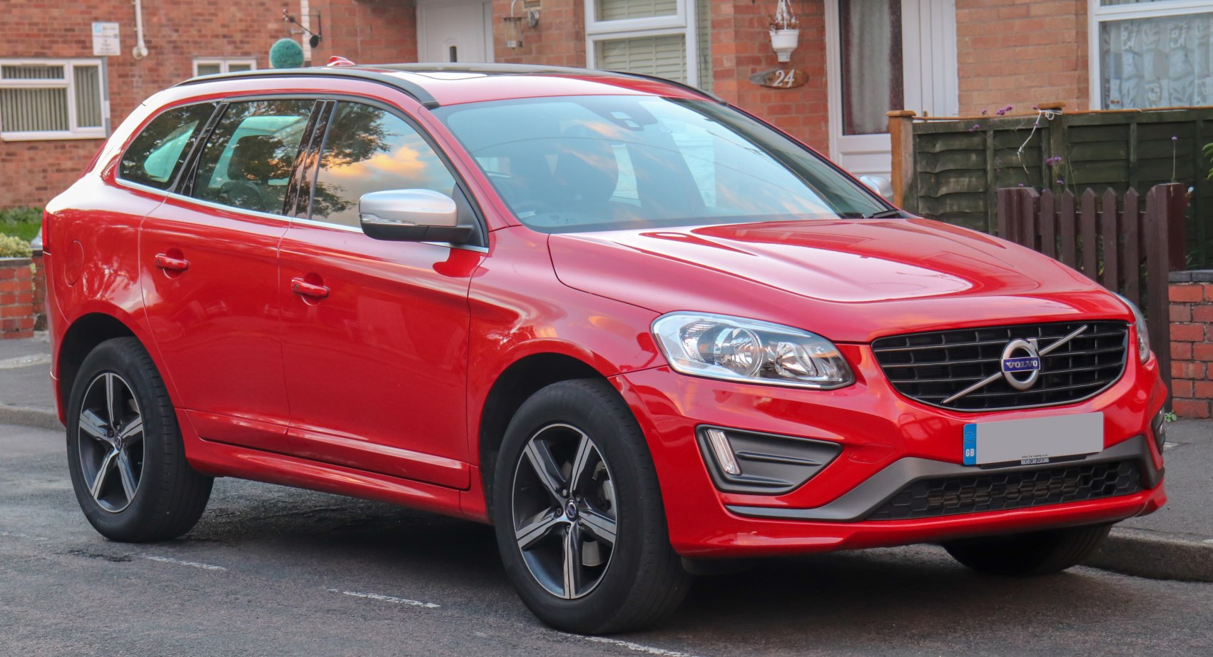 Front side view of red SUV with alloy wheels and modern design