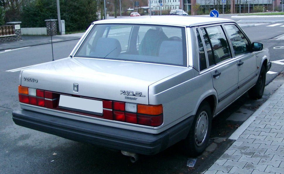 Classic 1980s boxy sedan rear with signature taillights and simple bumper