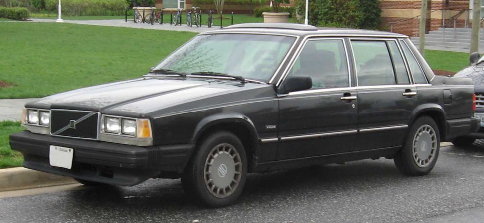 Black 1985 sedan with iconic boxy front side profile and steel wheels