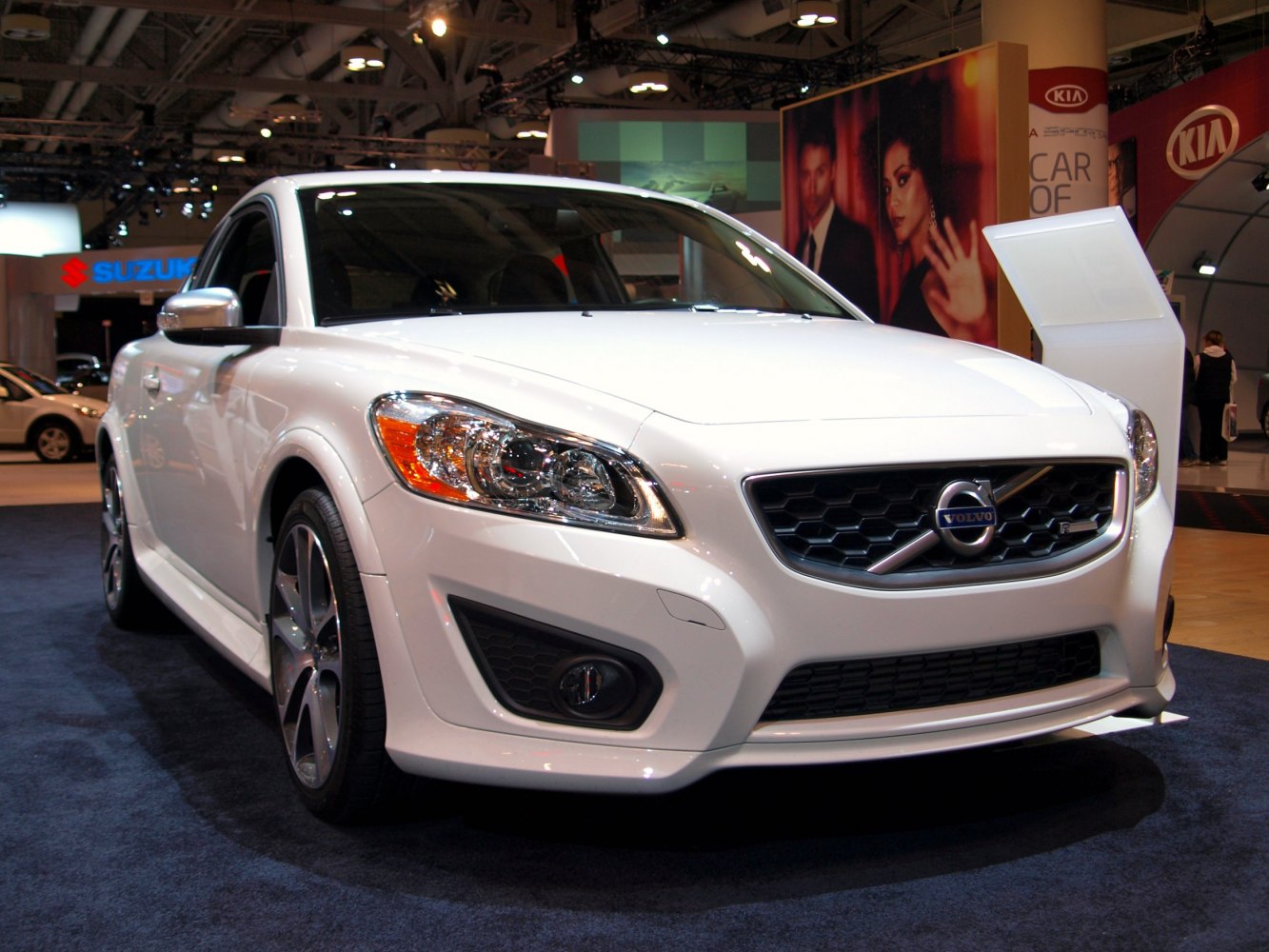 Front view showing modern headlights and sporty grille of a white compact hatchback.