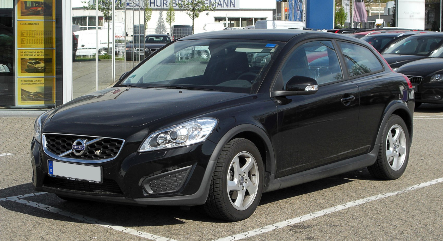 Front and side view of a black hatchback with alloy wheels and distinctive headlights