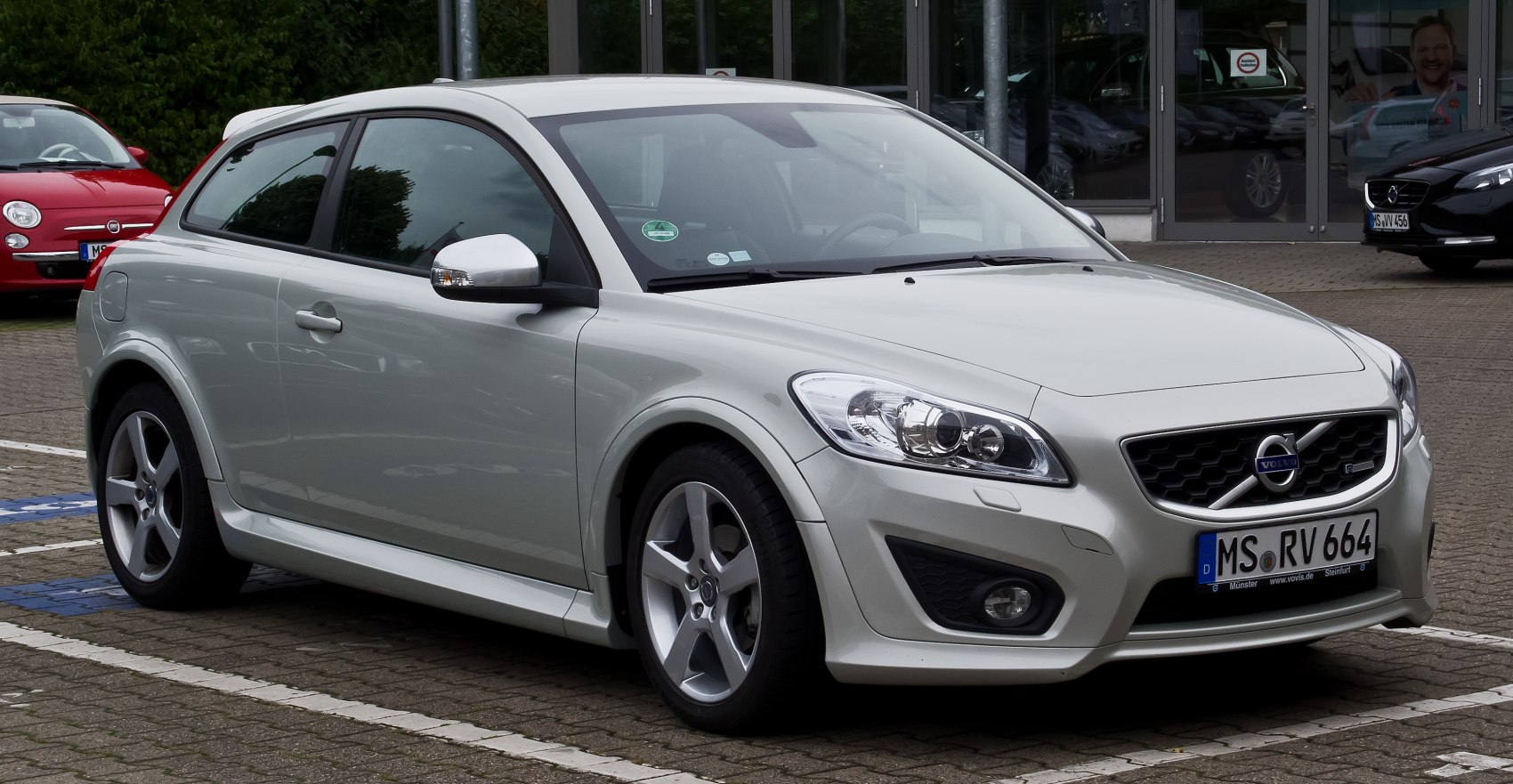 Front side view of compact hatchback with sporty wheels and clear headlights