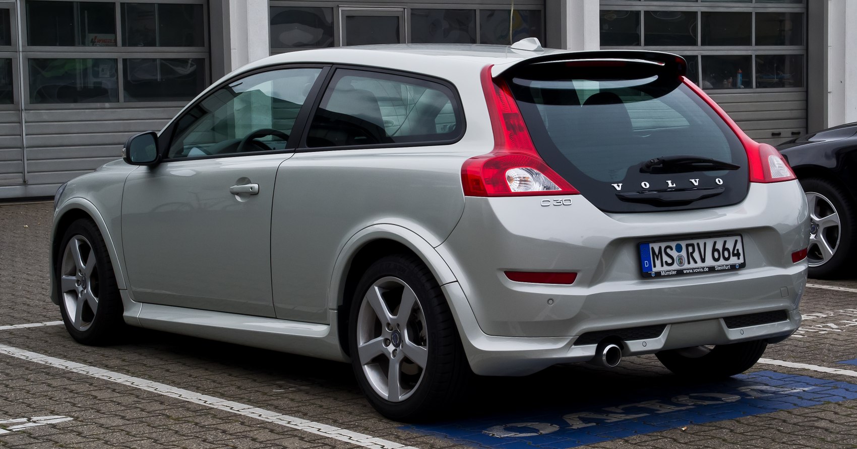 Rear view of hatchback with taillights and alloy wheels