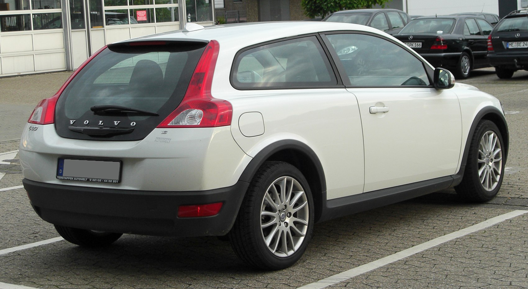 Rear side view of a compact hatchback with distinctive taillights and alloy wheels