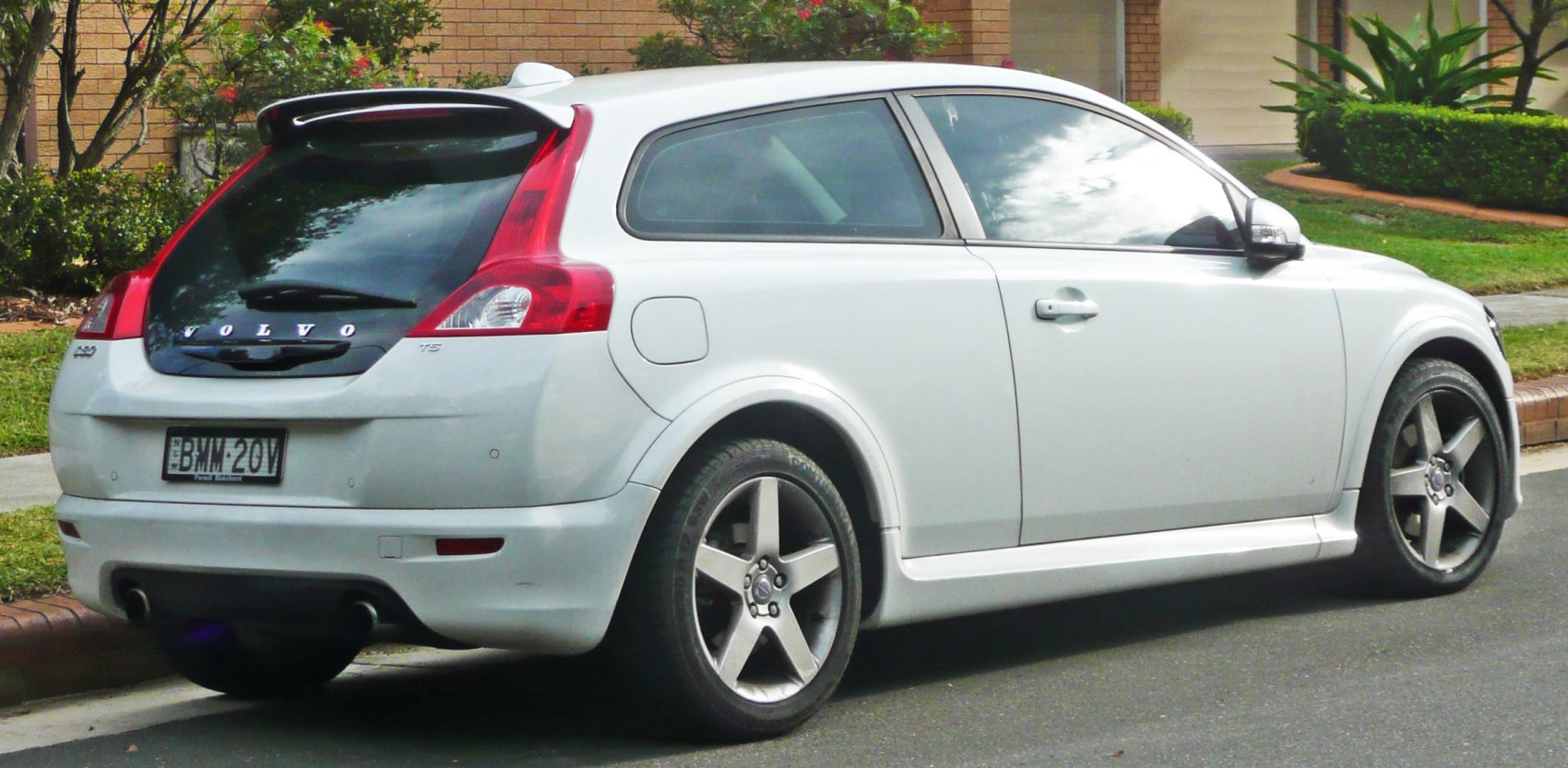 Rear-side view of hatchback with vertical tail lights and rear spoiler