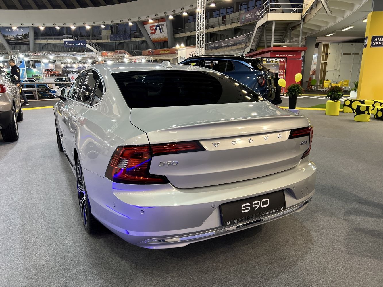 White luxury sedan rear with LED taillights and sleek trunk design
