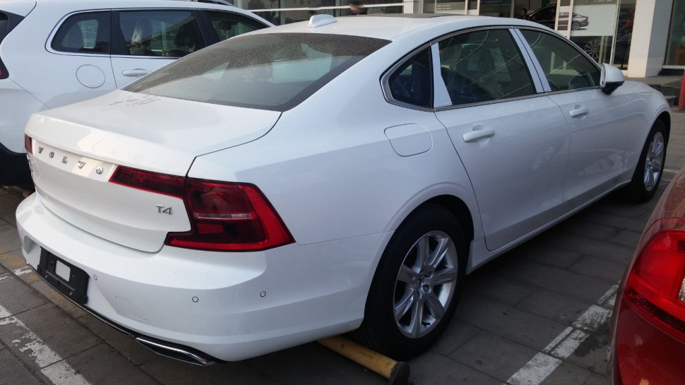Rear and side view of white modern sedan with T4 badge and alloy wheels