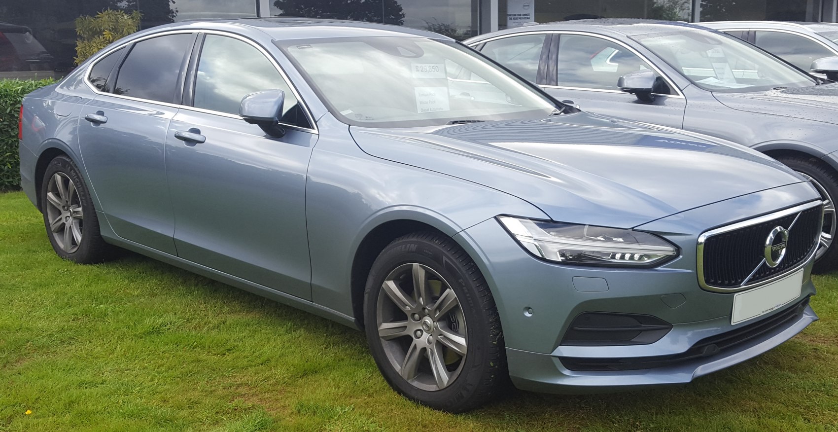 Luxury sedan front side view with modern headlights and alloy wheels