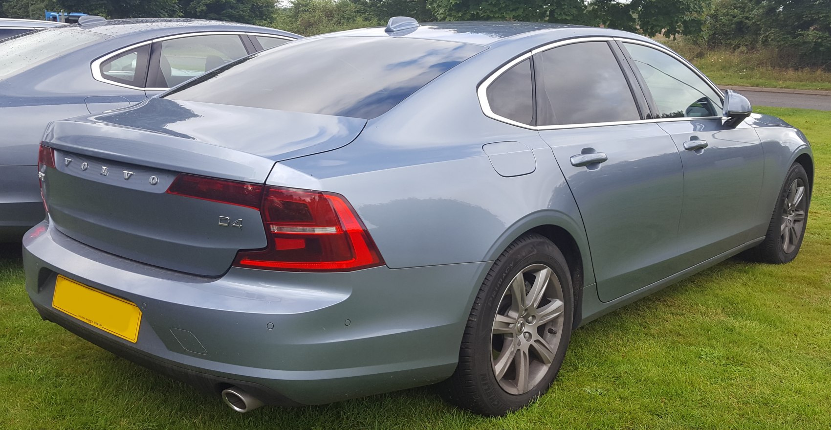 Rear view of sedan with distinct tail lights and dual exhaust pipe