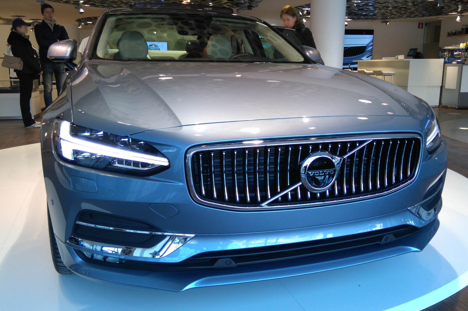 Front view of luxury sedan with LED headlights and chrome grille