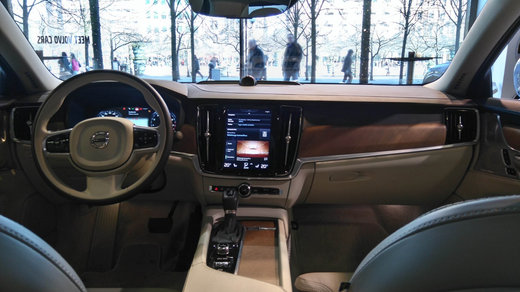 Luxury interior with touchscreen, leather steering wheel, and wood dashboard trim