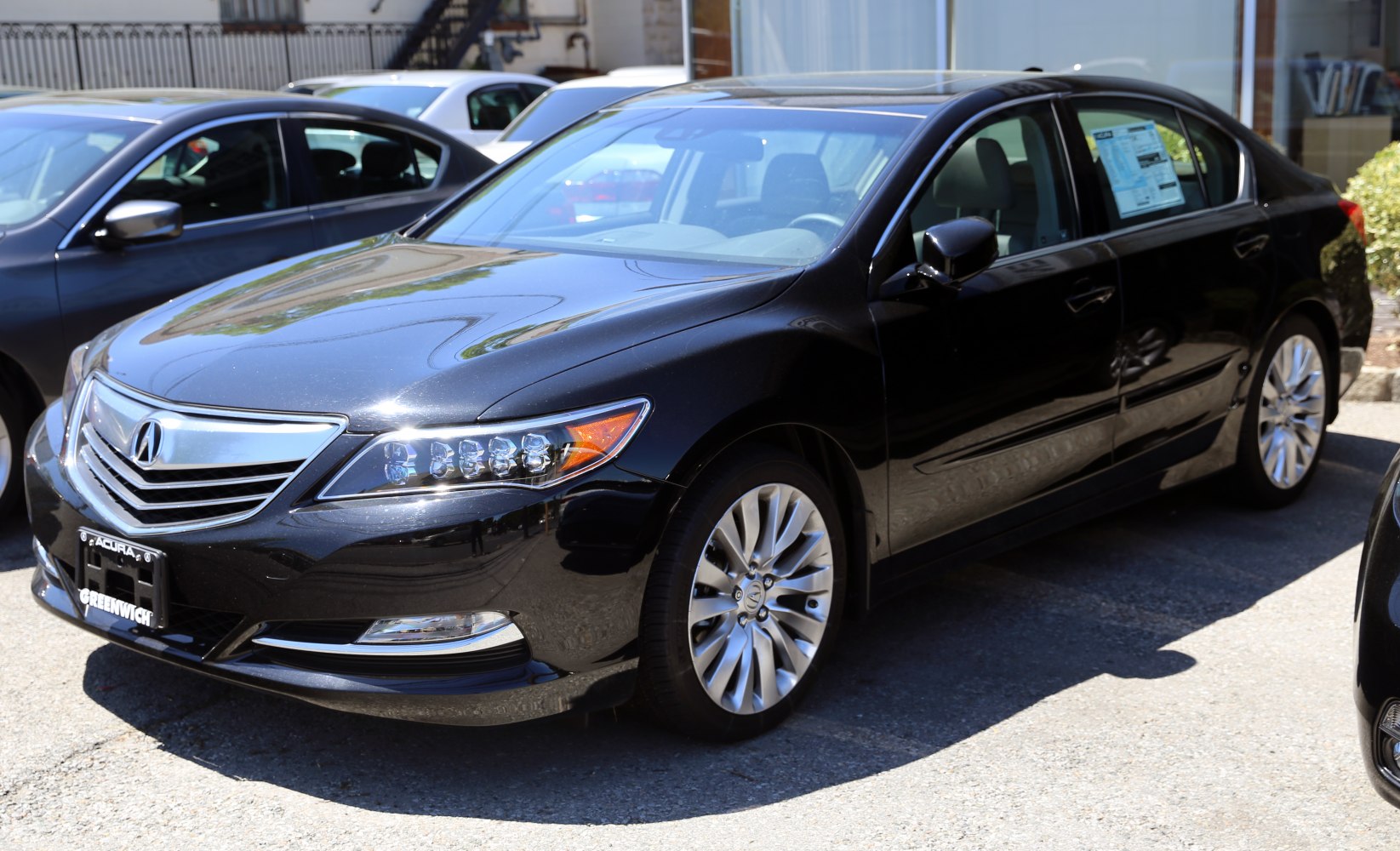 Multi-LED headlights and alloy wheels on luxury sedan front view