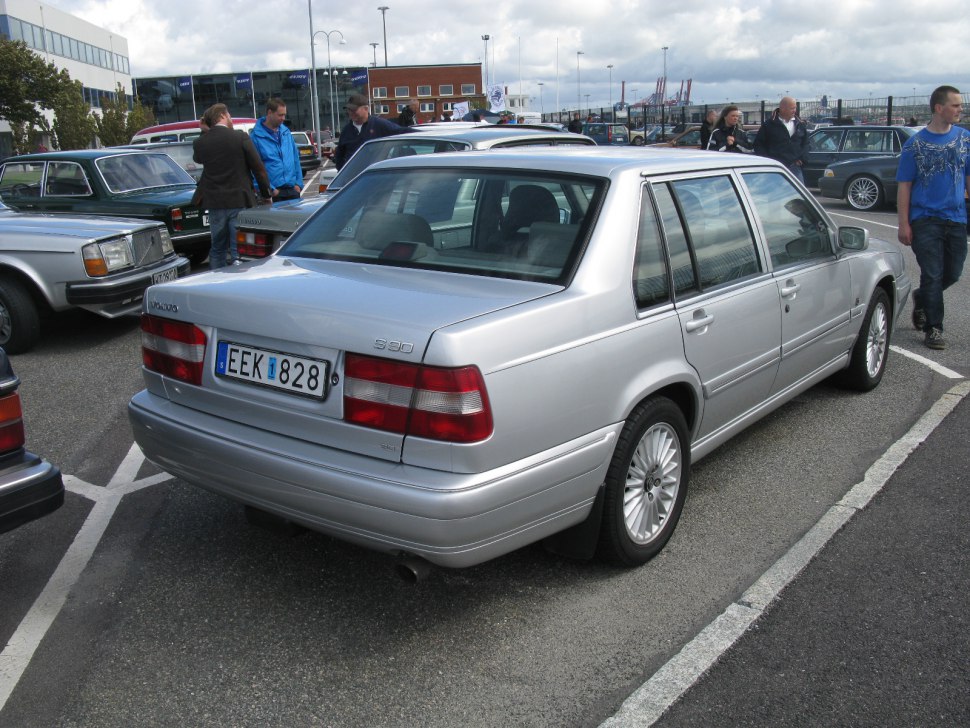 Rear view of a silver mid-size sedan with distinct tail lights and alloy wheels