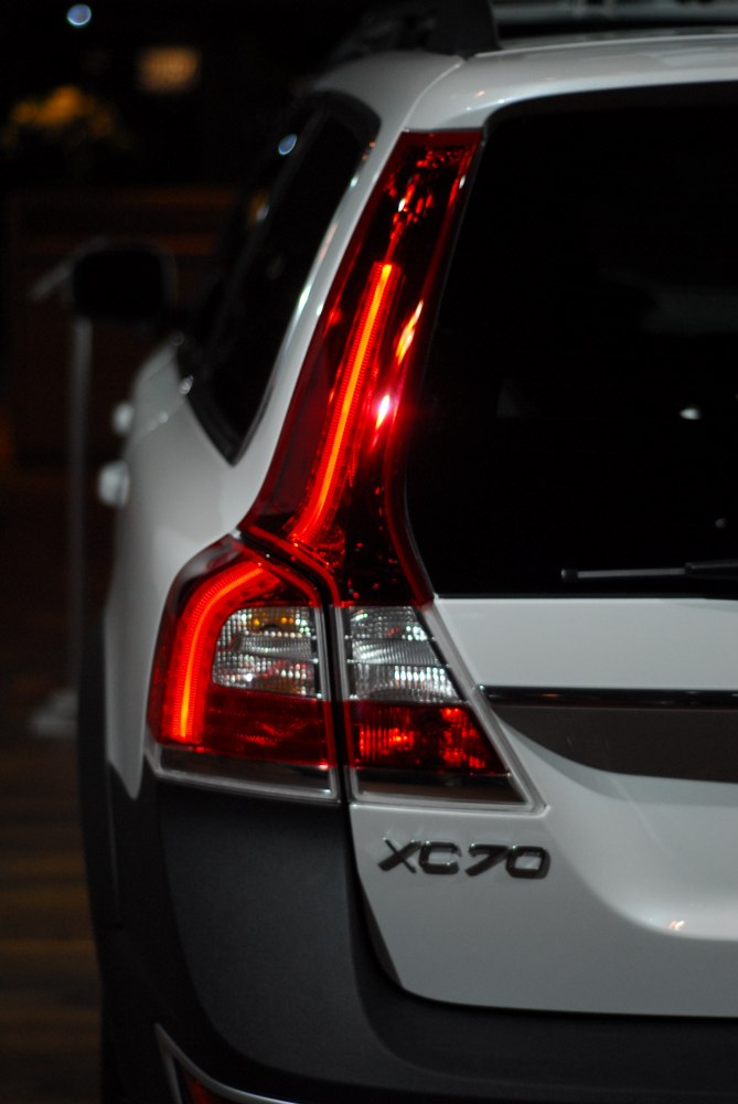 Vertical red rear taillight and XC70 badge on white vehicle