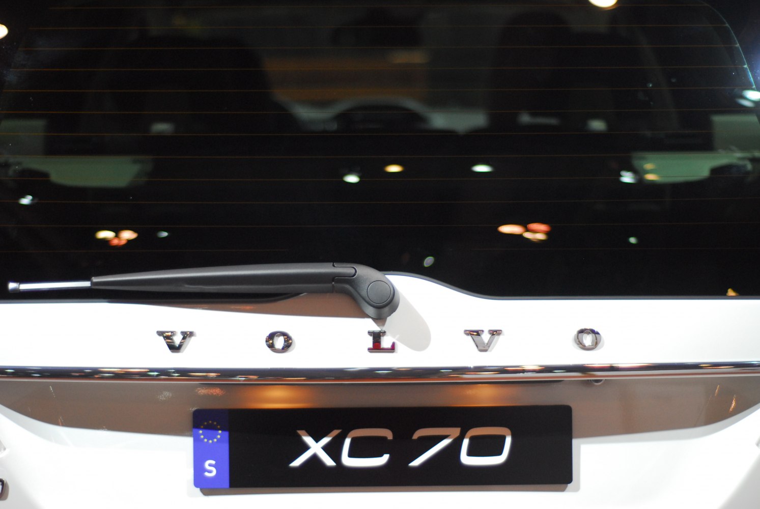 Rear windshield wiper and Volvo lettering on white vehicle