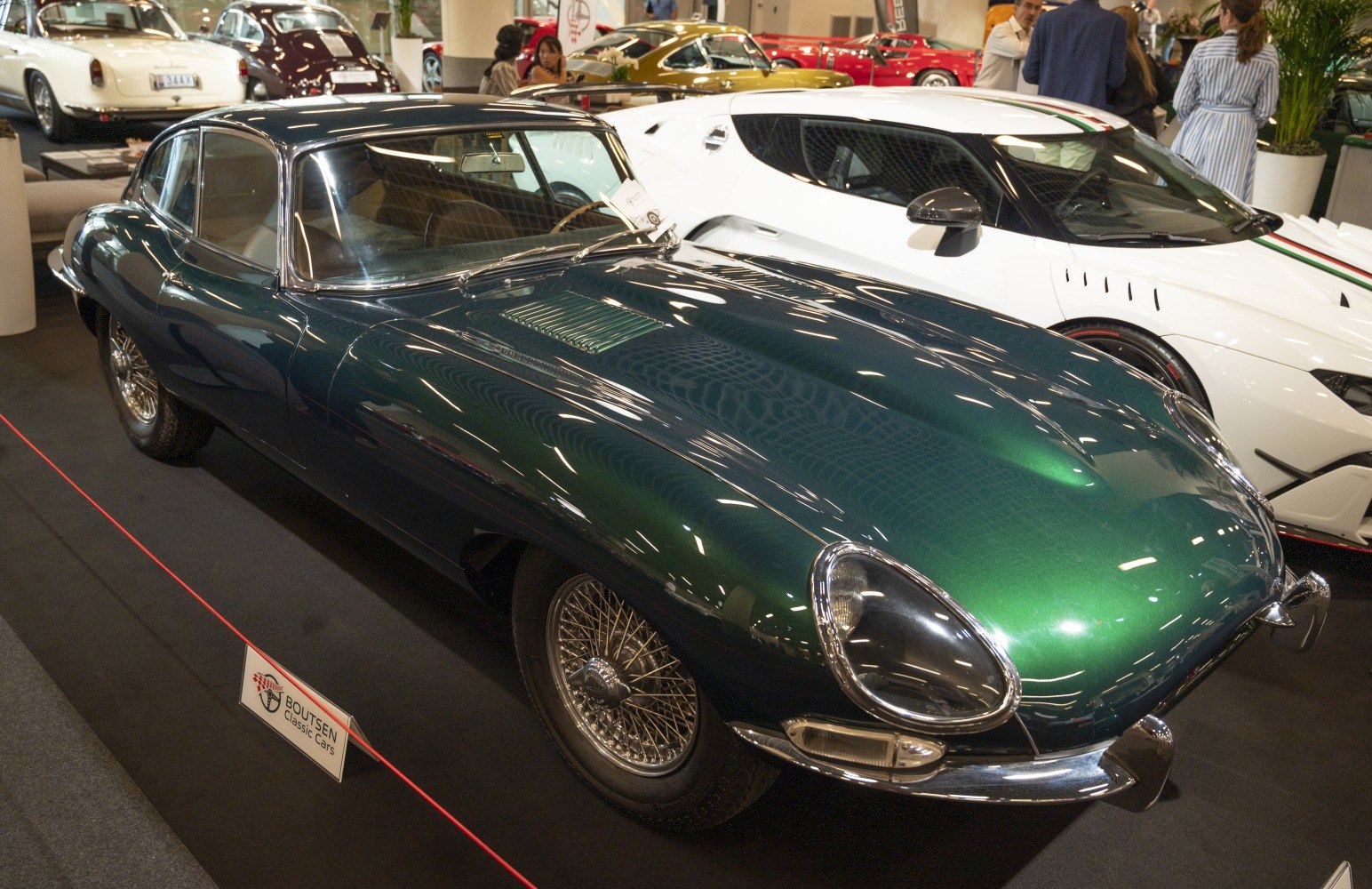 Curved sleek body with wire-spoke wheels and vintage sports car design