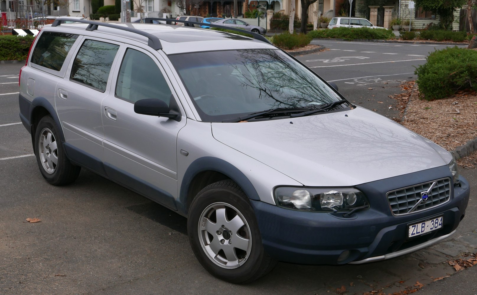 Front side view of a silver station wagon with plastic cladding and roof rails