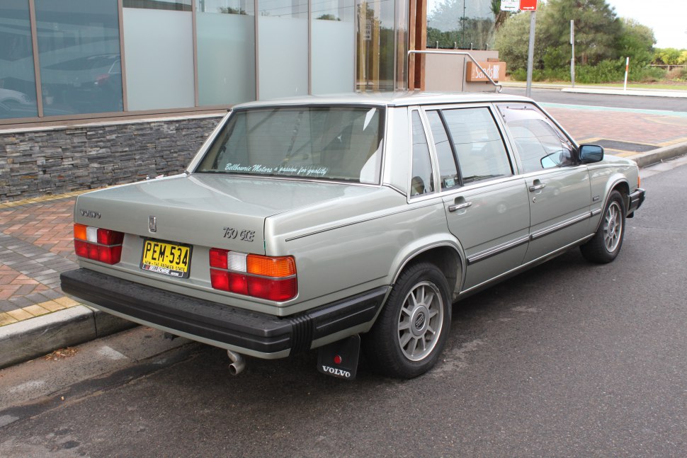 Rear and side profile of a classic vintage sedan with distinctive taillights and boxy design.