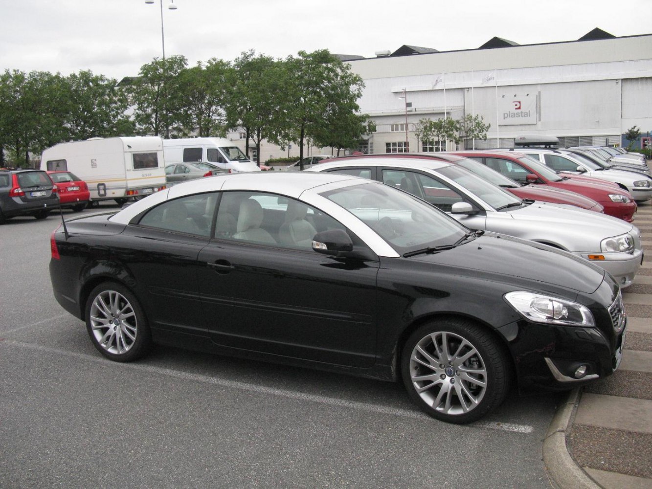Black coupe cabrio with silver roof trim and alloy wheels