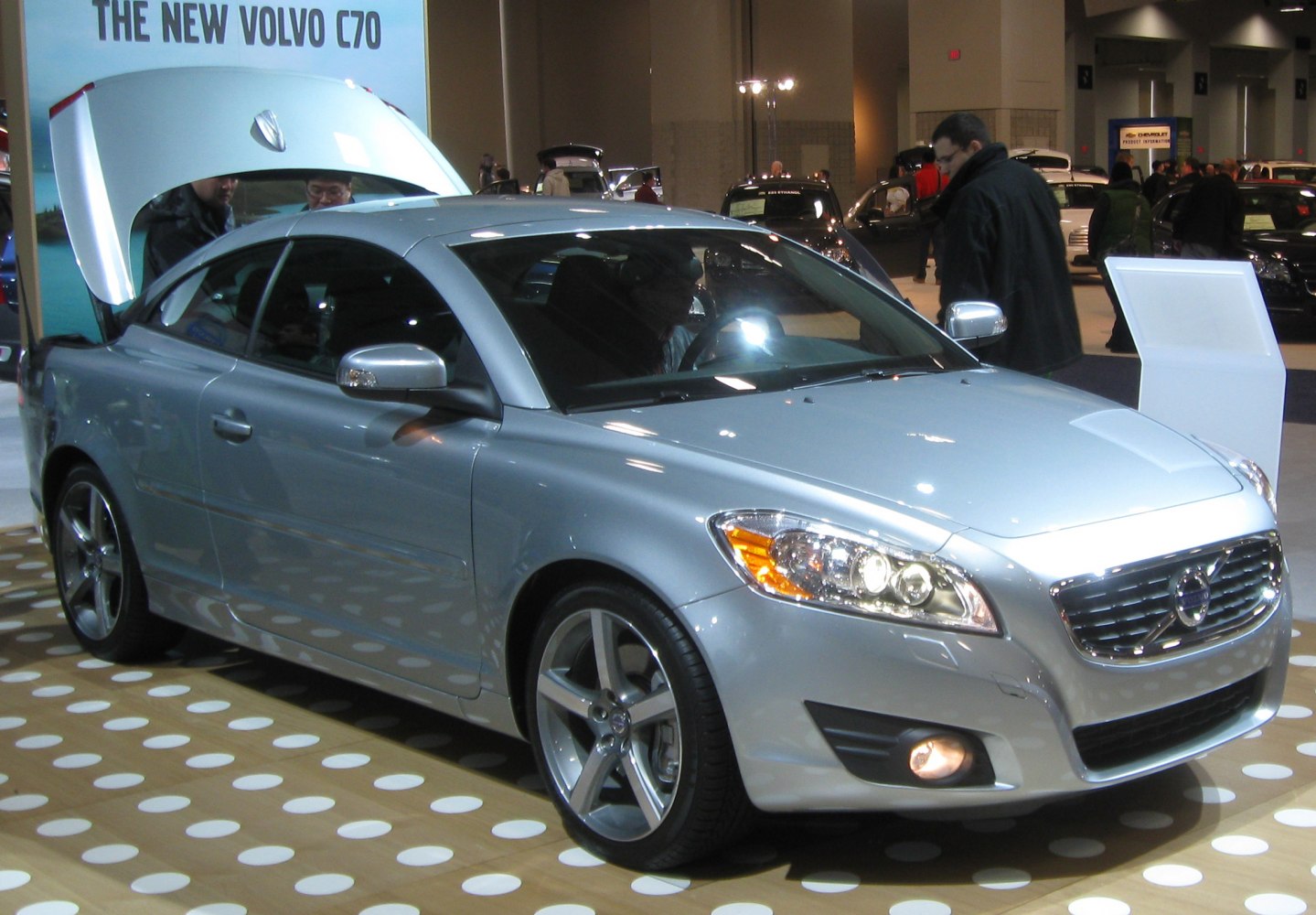 Silver coupe with alloy wheels and detailed front headlights
