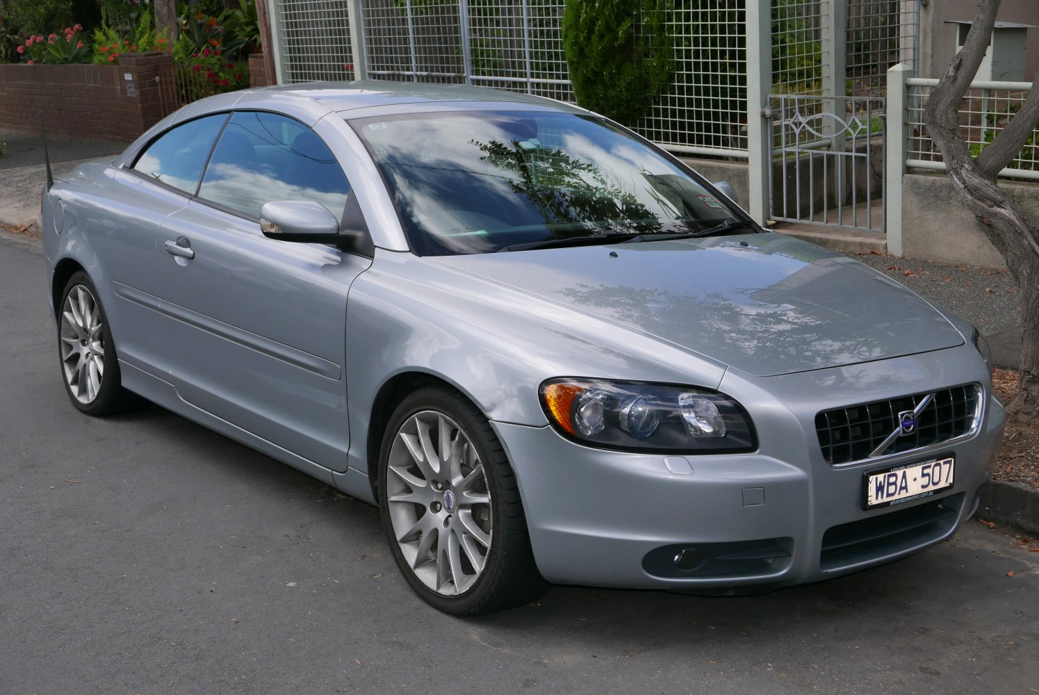 Front side view of a silver coupe with sporty wheels and aerodynamic design.