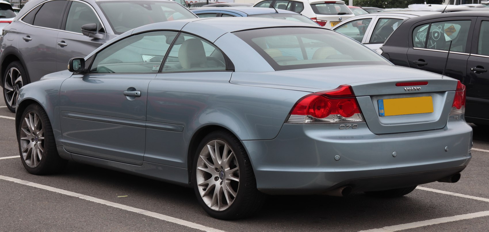 Rear view of a coupe convertible with alloy wheels and distinctive taillights