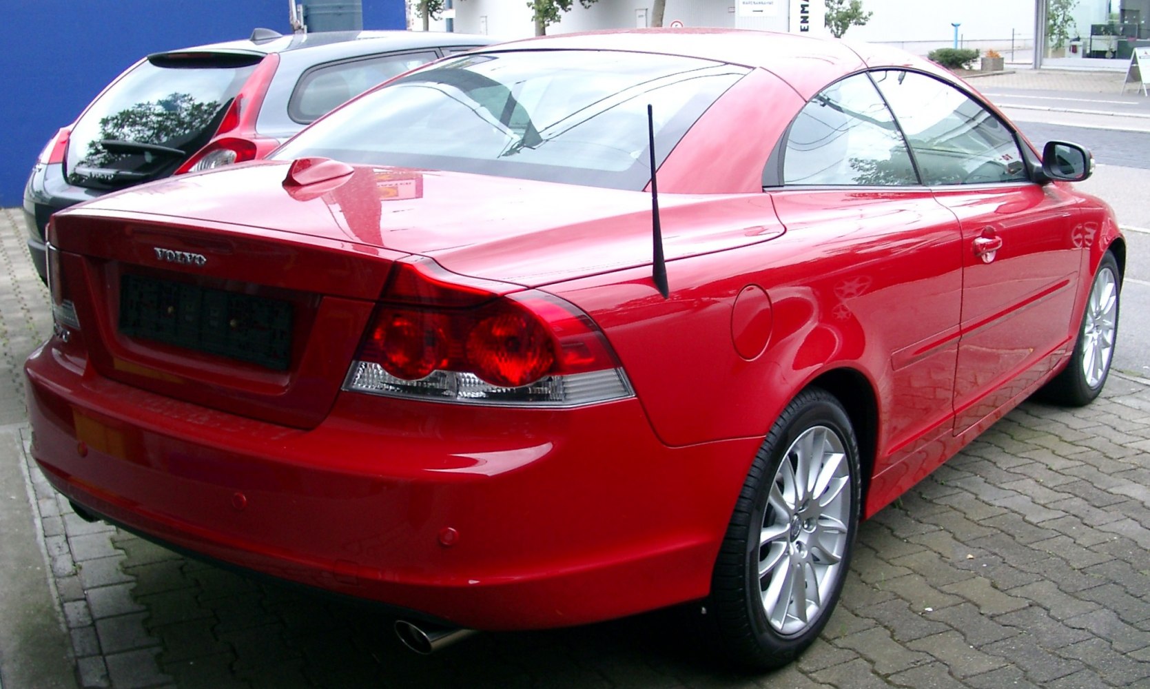 Red coupe cabrio rear view with sleek taillights and alloy wheels