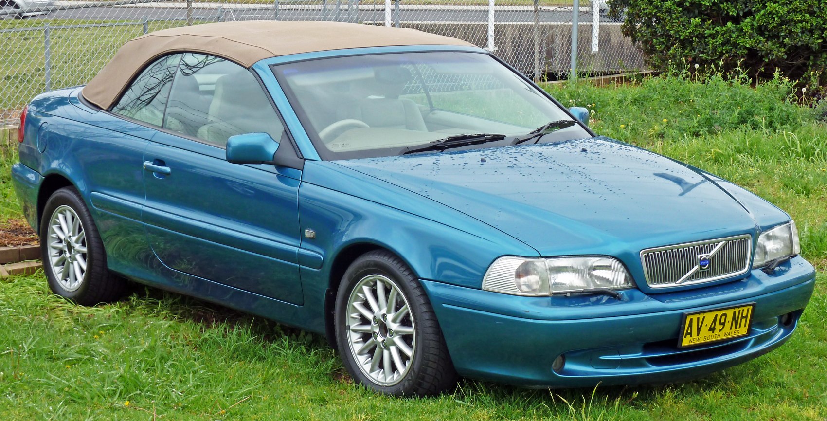 Blue convertible with beige soft top and alloy wheels