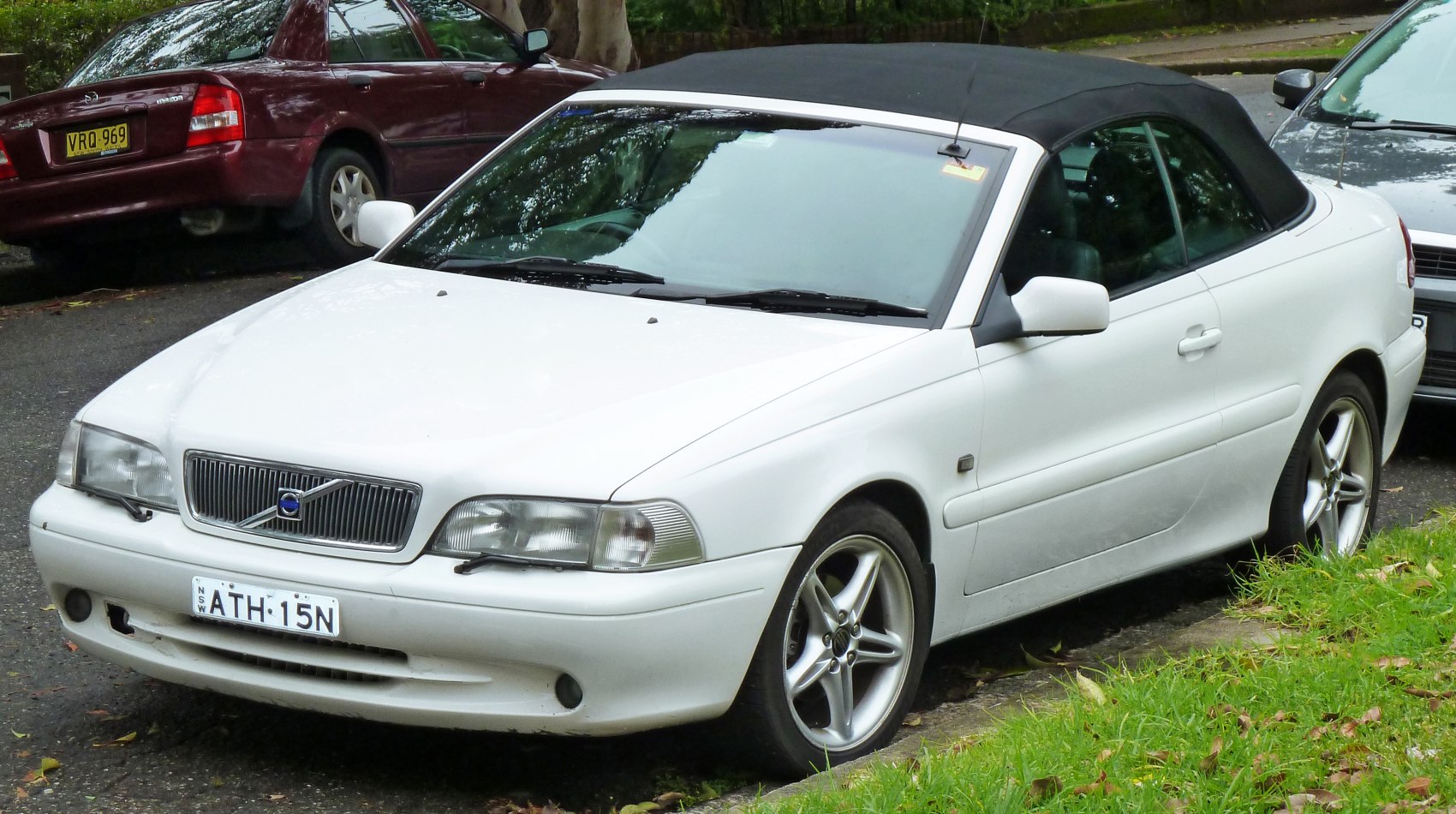 White convertible with black soft top roof and alloy wheels
