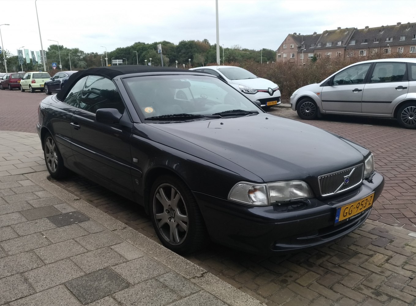 Black convertible with soft-top roof, front and side view