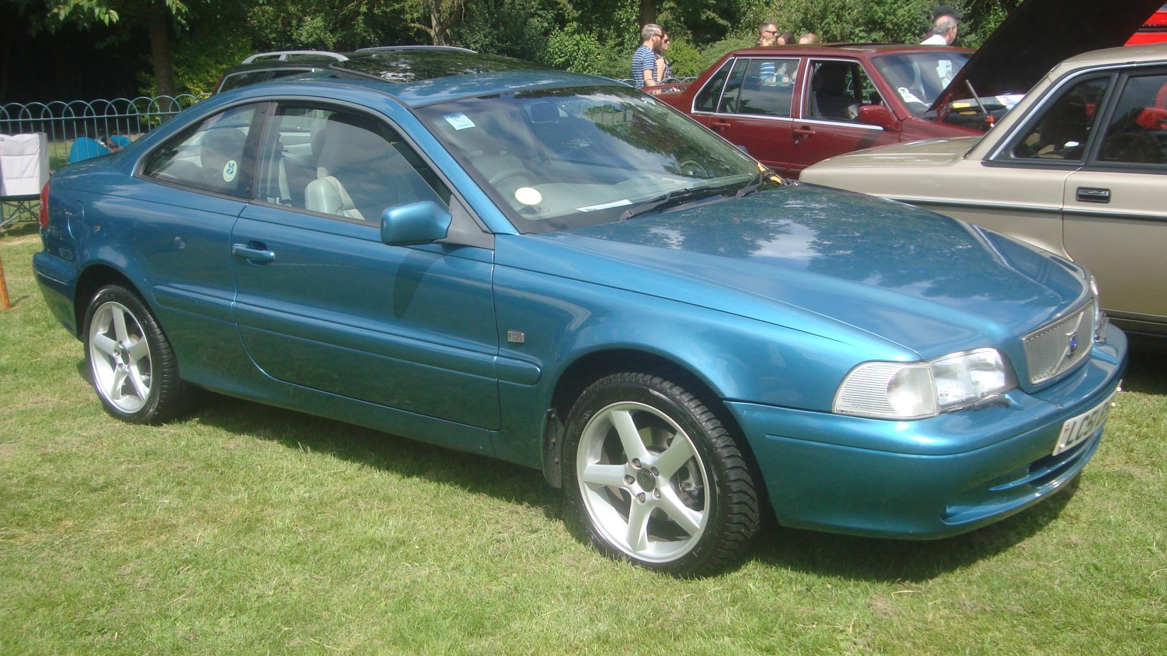 Blue two-door coupe with alloy wheels and sleek design