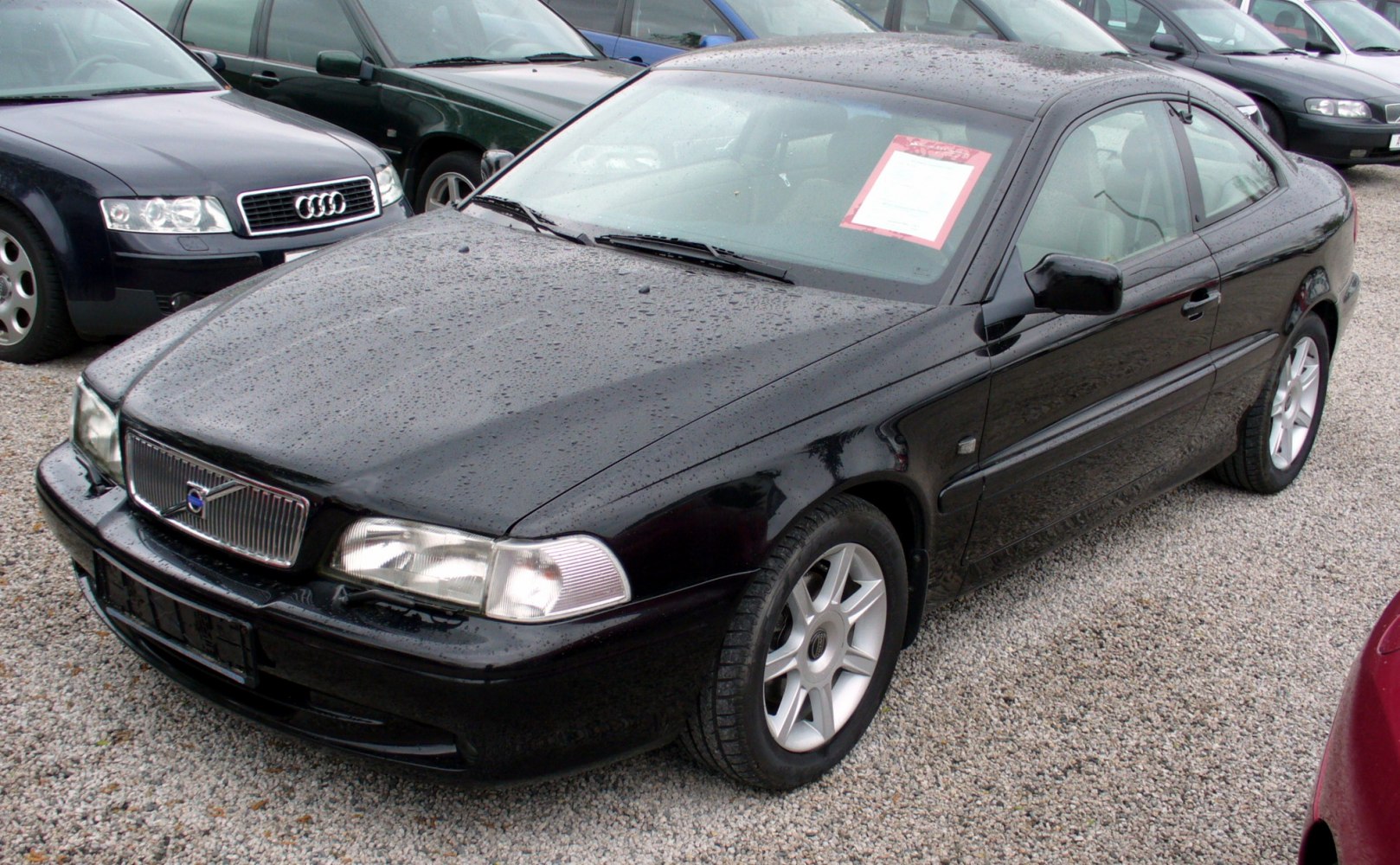 Two-door coupe with distinctive front grille and alloy wheels in black exterior.