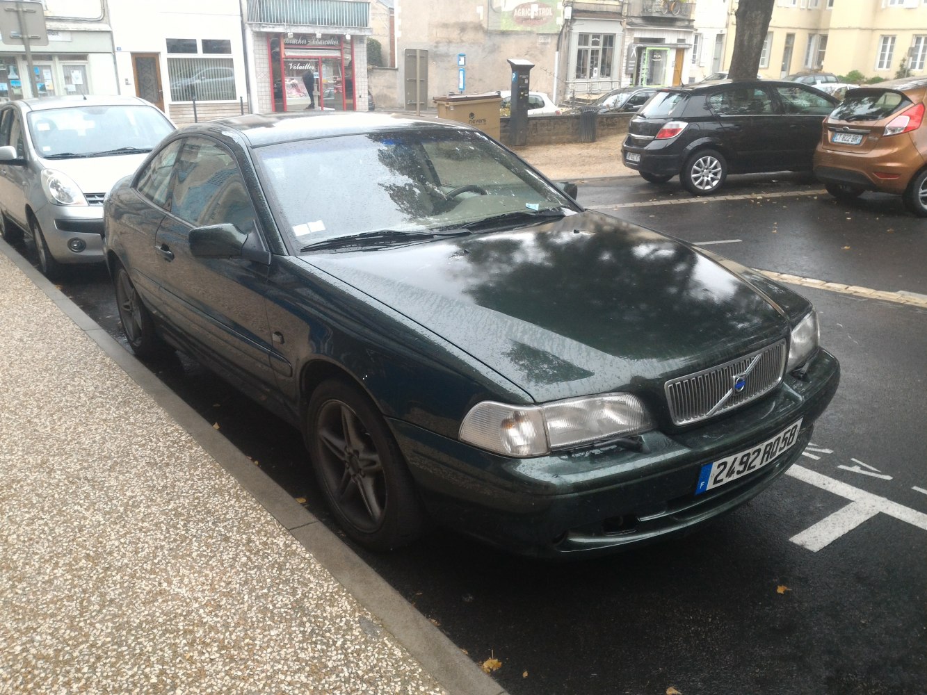 Front side view of a coupe with distinctive grille and sleek profile.