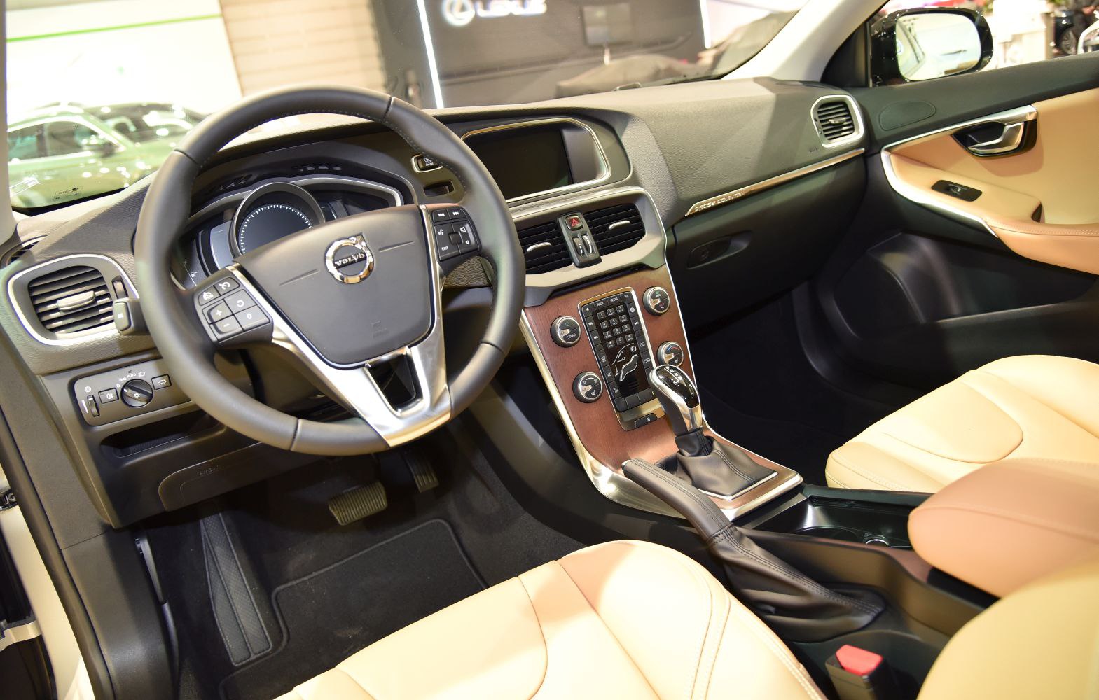 Luxury car interior with leather seats, steering wheel, and center console controls