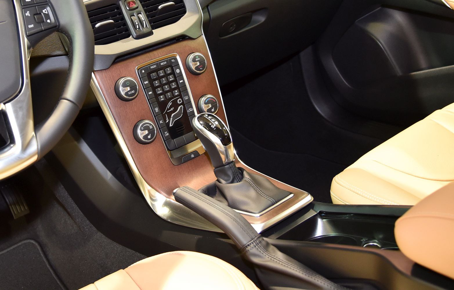 Gear shift lever and wood-trimmed central control panel with climate and audio controls