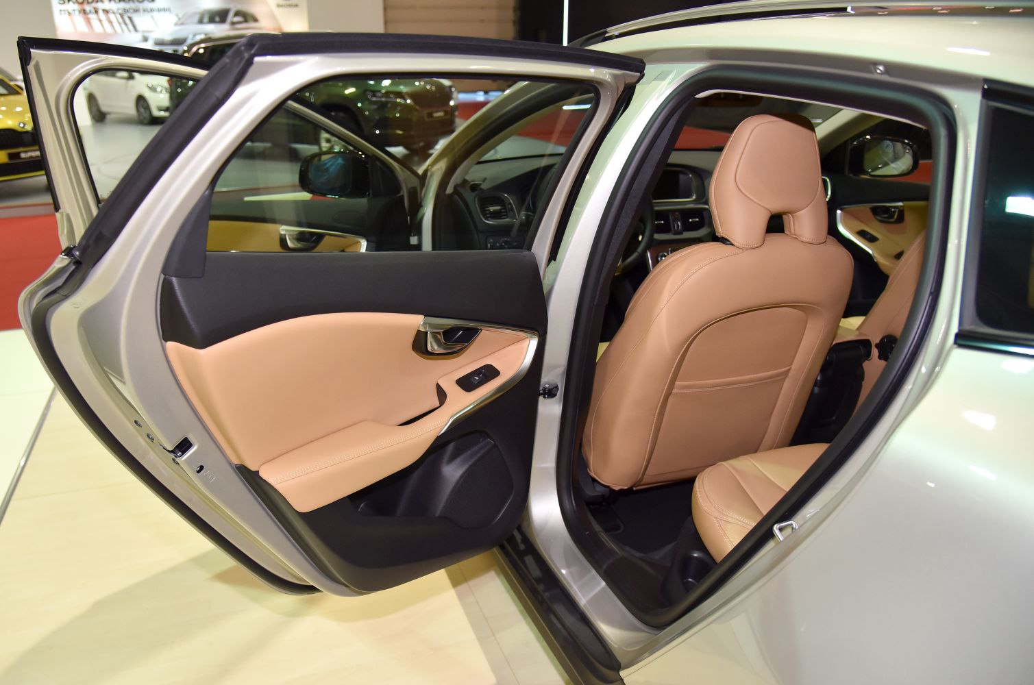 Open rear door with tan leather seat and door panel