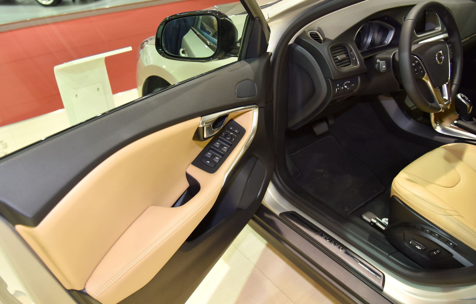 Driver door panel and interior controls with beige upholstery