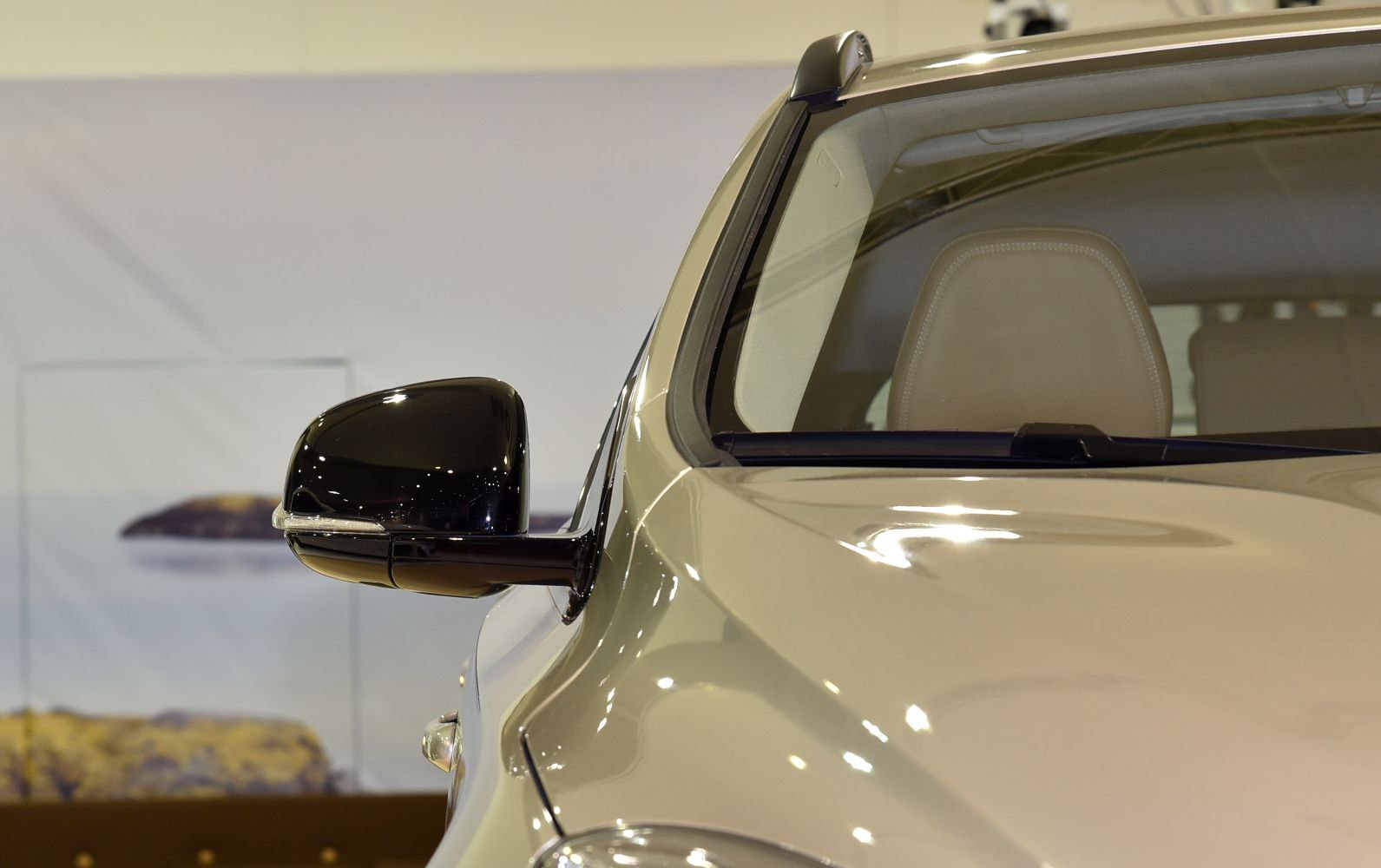 Side mirror and roof rail detail on a car front corner