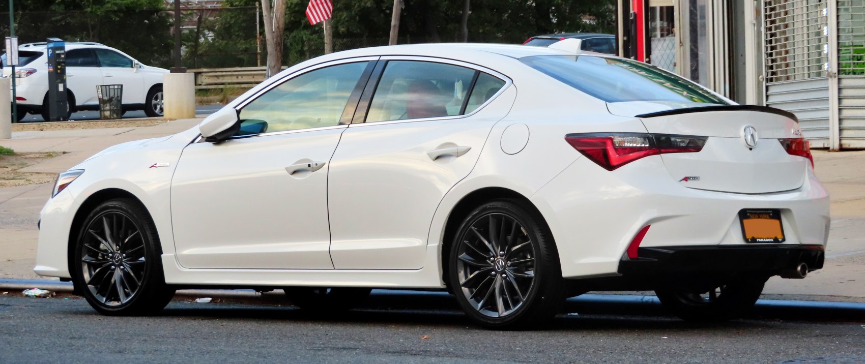 Side and rear view of a sedan with black alloy wheels
