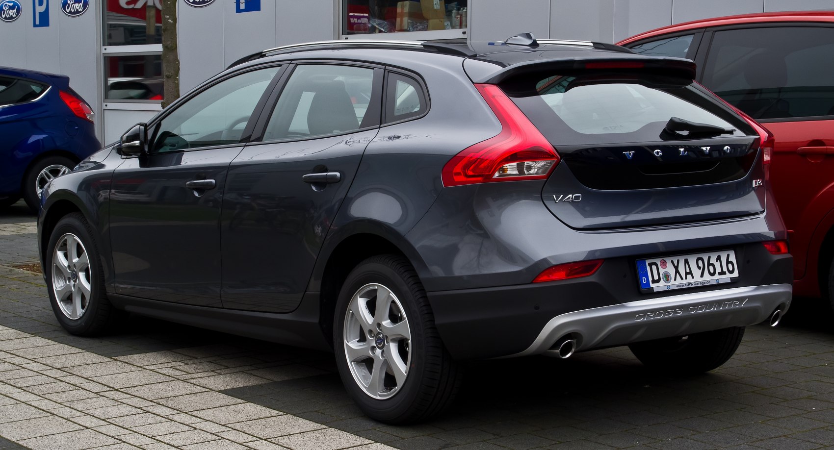 Rear-side view of hatchback with distinctive taillights and roof spoiler