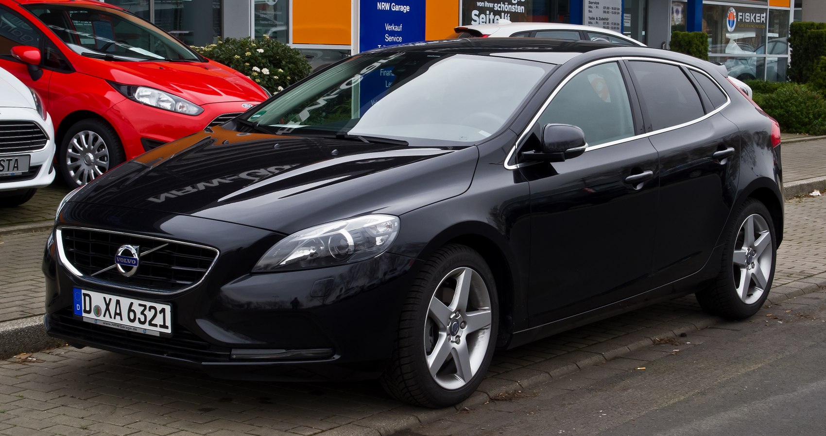 Sleek black hatchback front-side view with modern headlights and alloy wheels