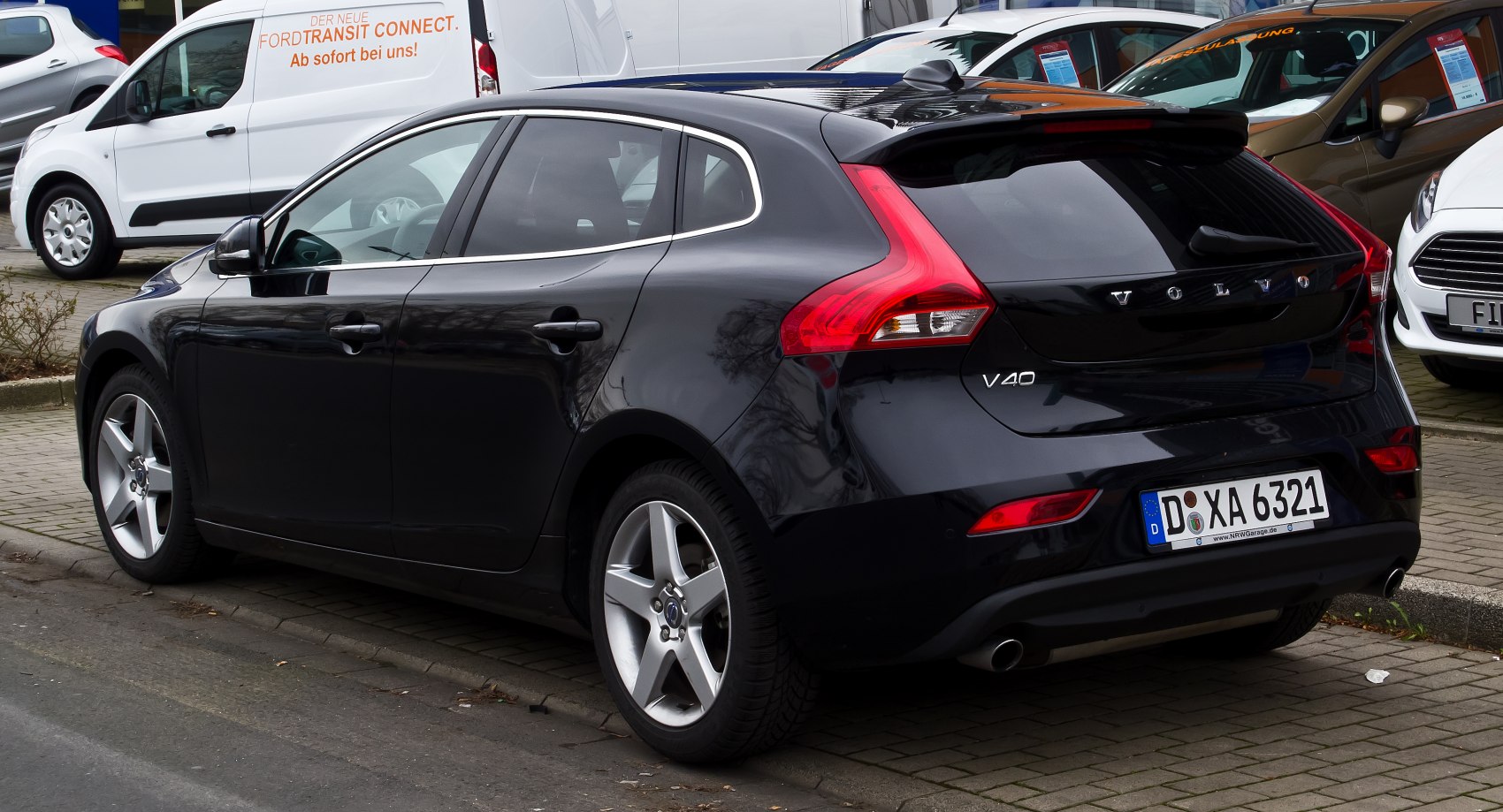 Rear hatchback view with vertical tail lights and chrome window trim