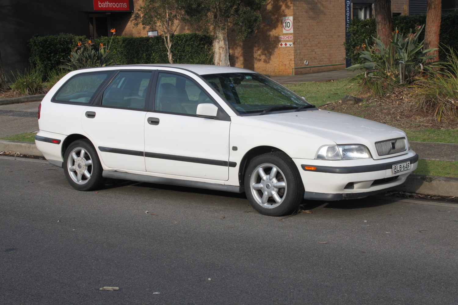 White 1996 station wagon side profile with alloy wheels