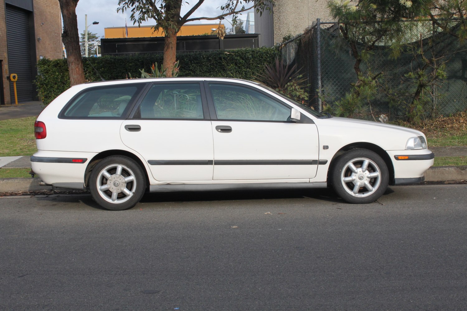White four-door wagon with long roof and black side trim