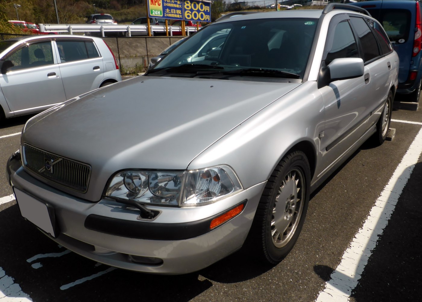 Silver station wagon front three-quarter view with distinctive headlights and grille