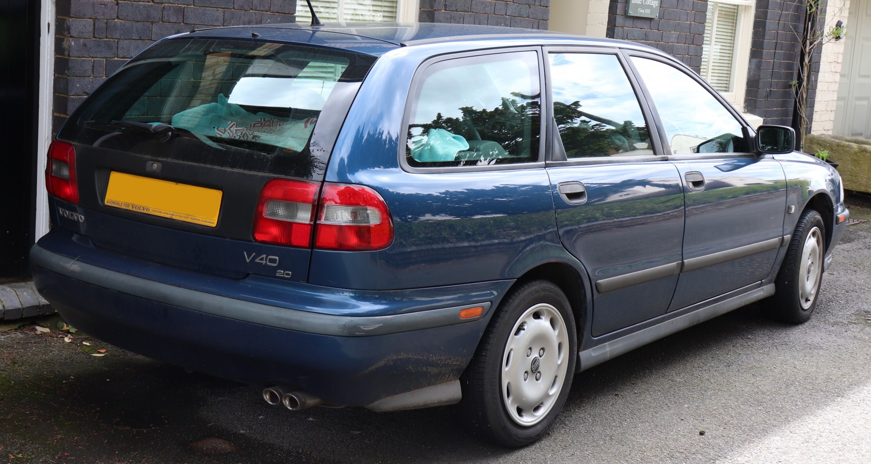Rear and side view of classic station wagon with dual exhaust and distinct taillights.